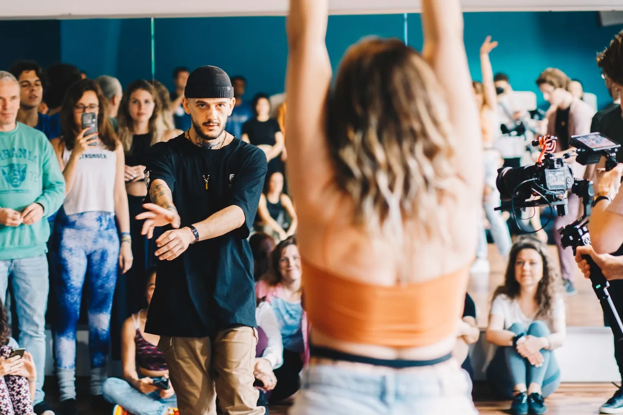 Gab demonstrating movement during a workshop while participants watch